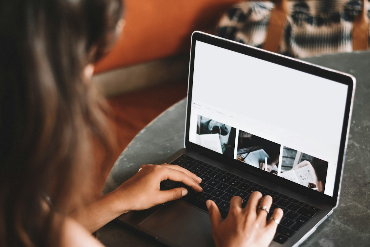 A video meeting in progress on a laptop with live transcription