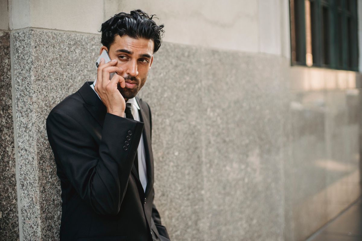 Businessman in a suit talking on a cell phone