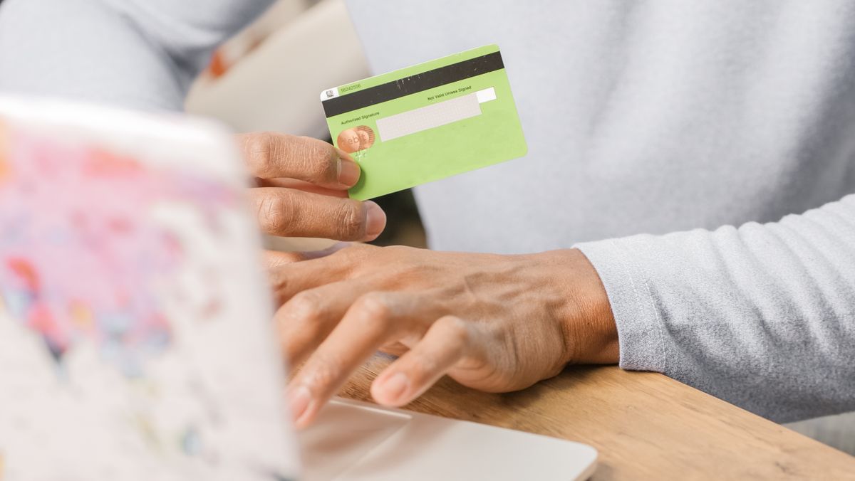 Close-up of a person holding a credit card