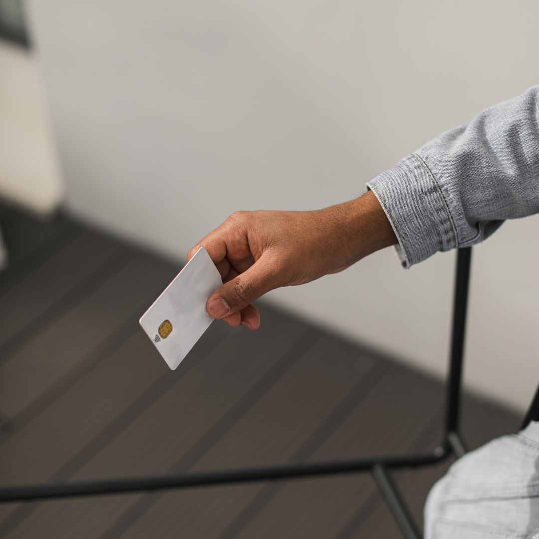 Hand holding a credit card in close-up