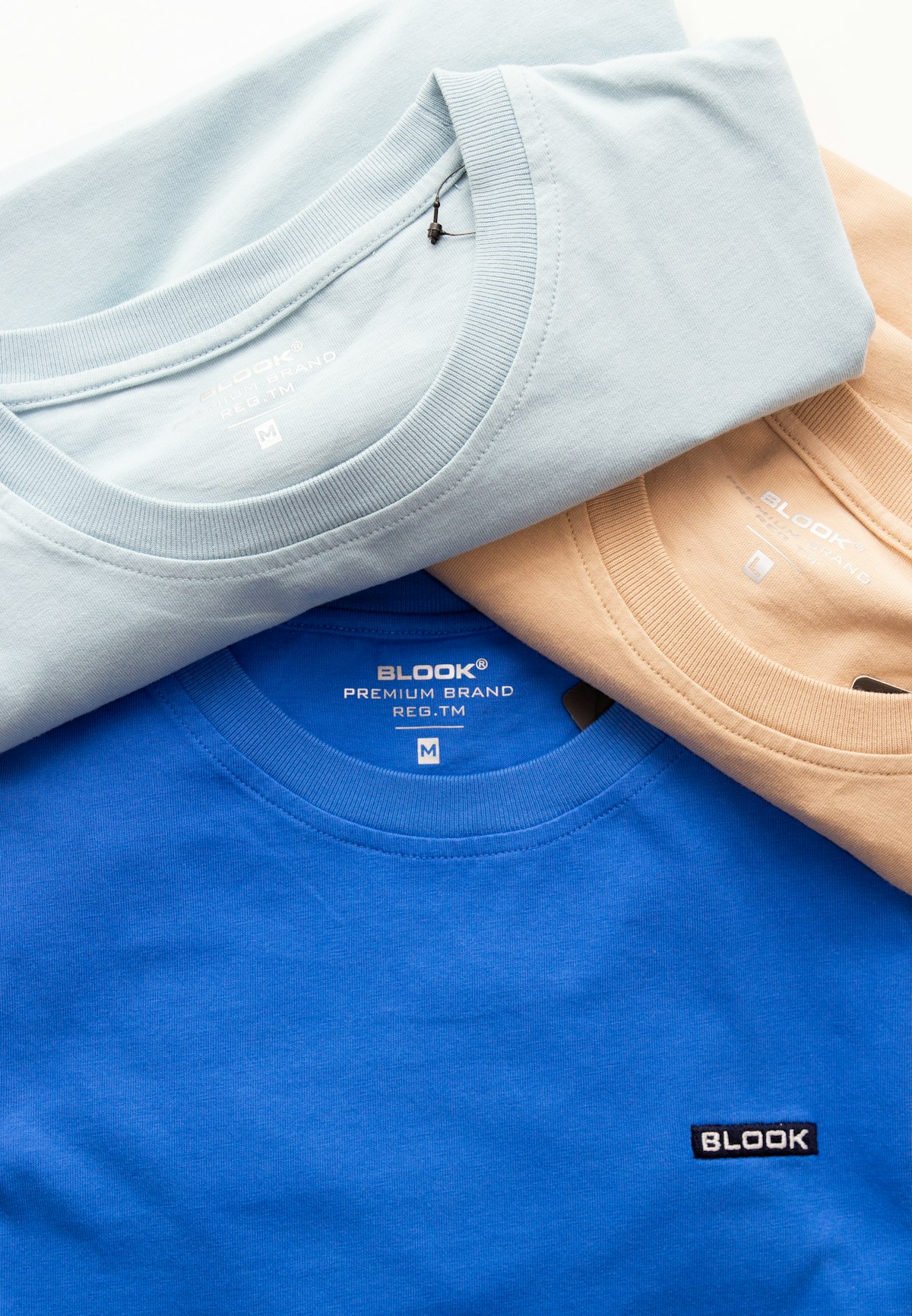 Folded custom t-shirts and mugs with niche designs ready for print-on-demand fulfillment