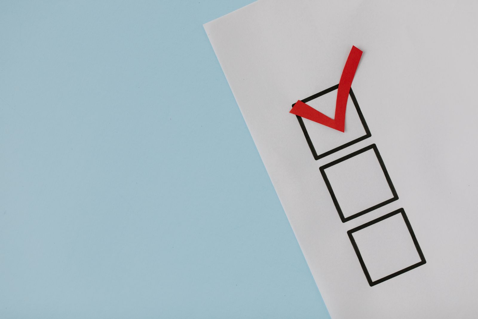 Paper checklist with a red checkmark, decision concept