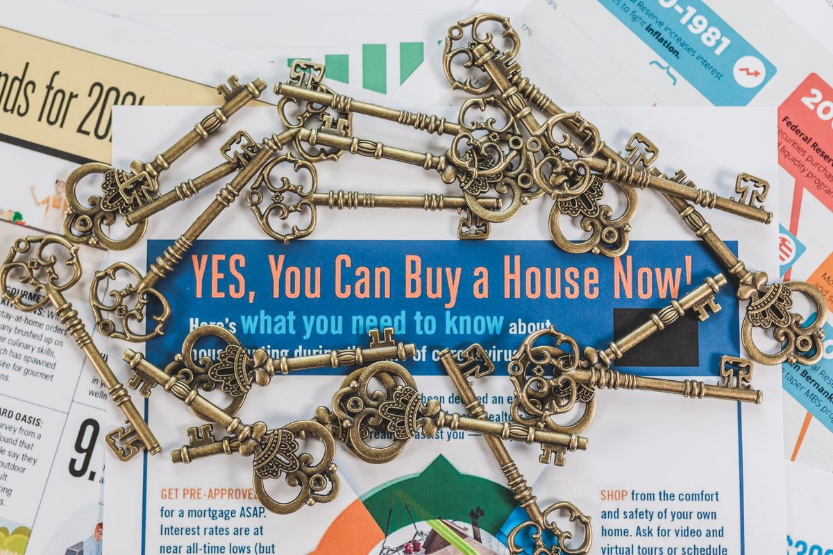 Vintage keys spread over real estate purchase documents
