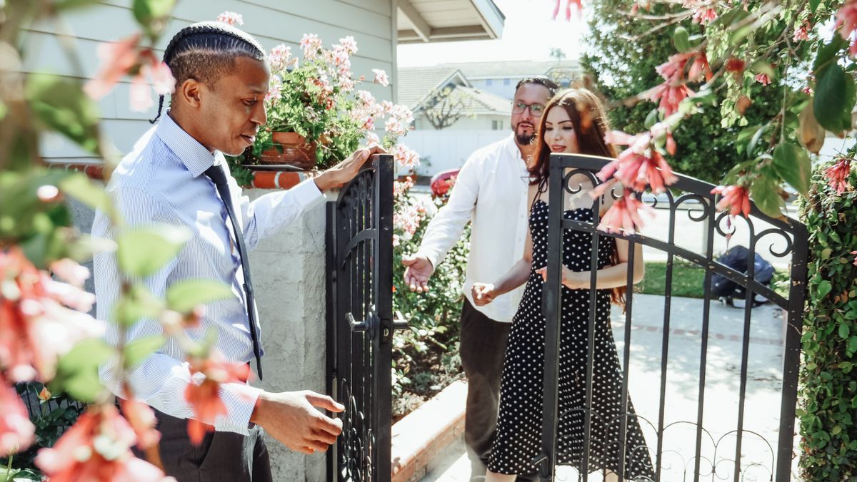 Realtor welcoming a couple to their new multi-unit house