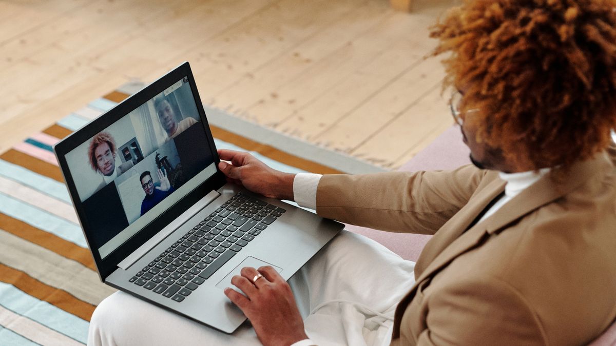 A solo founder on a video call with a client from a home office