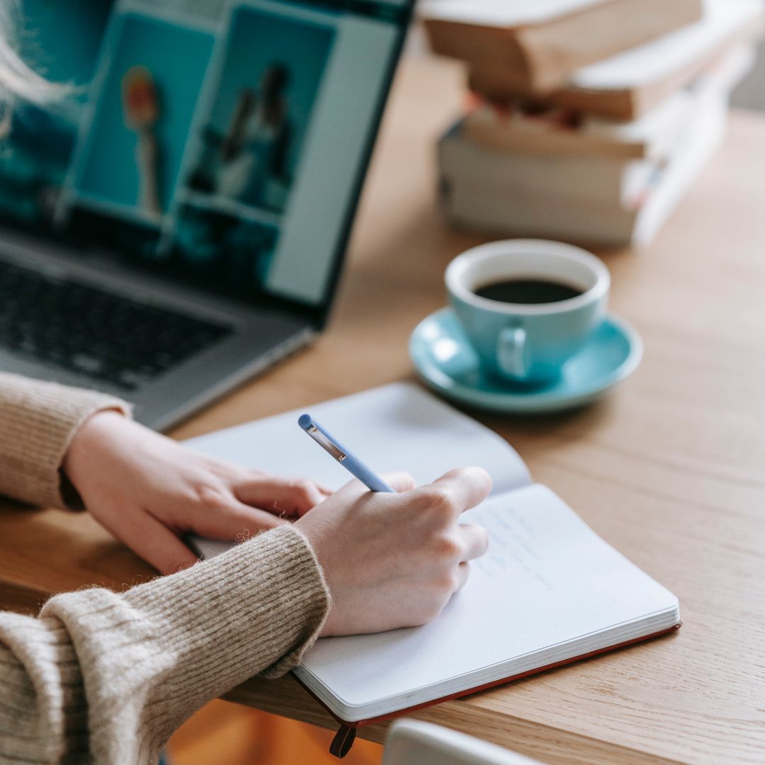 A notebook with business planning sketches and a cup of coffee on a desk
