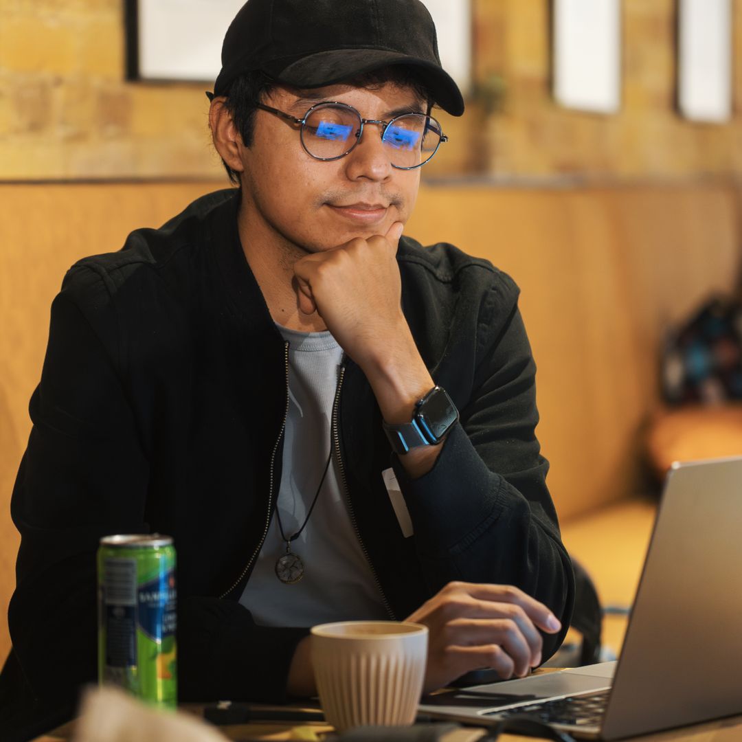A freelancer working on a laptop in a cafe, taking a break from the home office