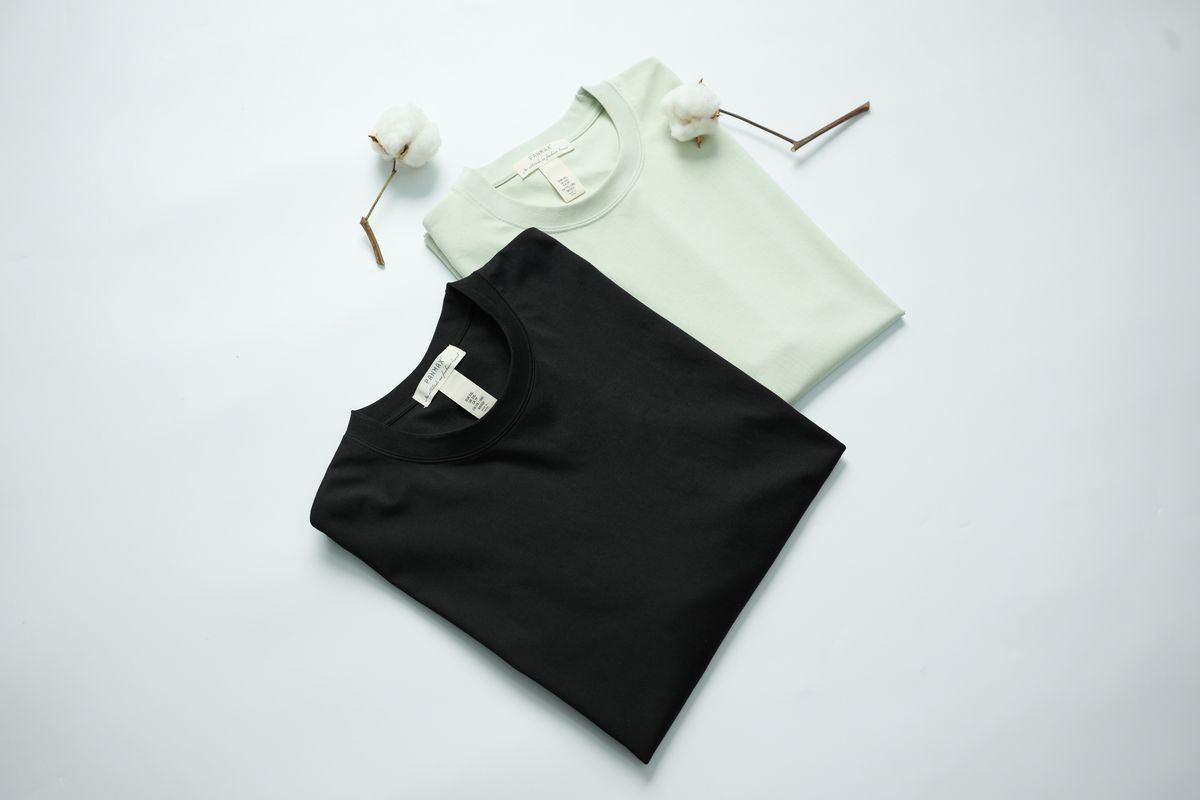 A t-shirt mockup flat lay on a table showing a printed design
