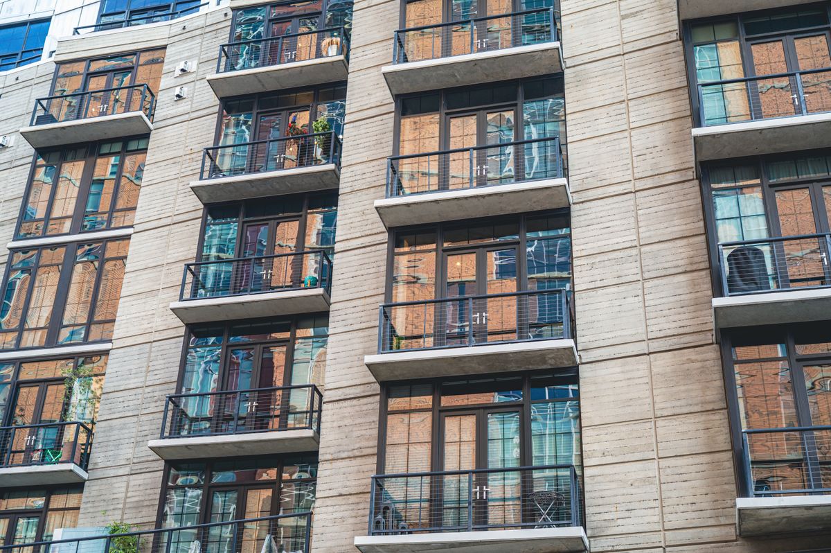Apartment building with glass balconies, low angle