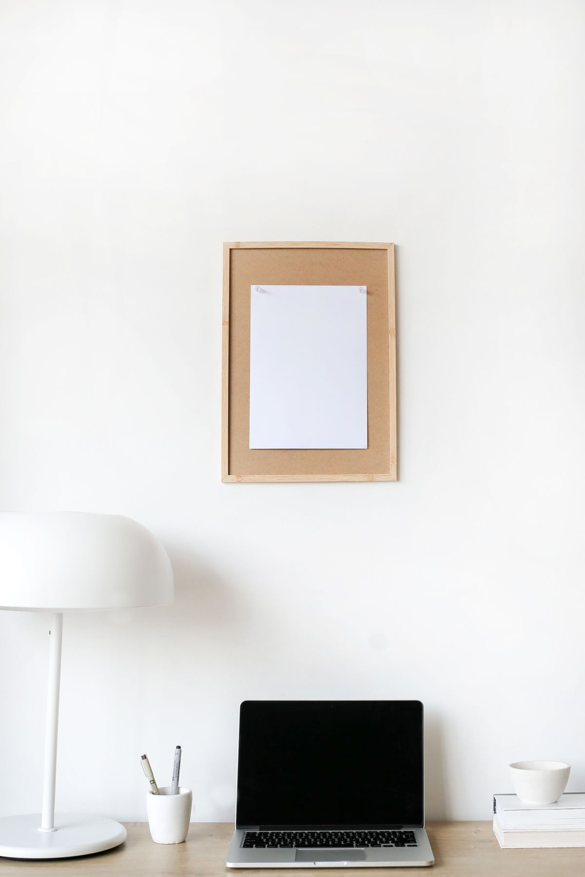 Minimalist desk setup with an open laptop and lamp